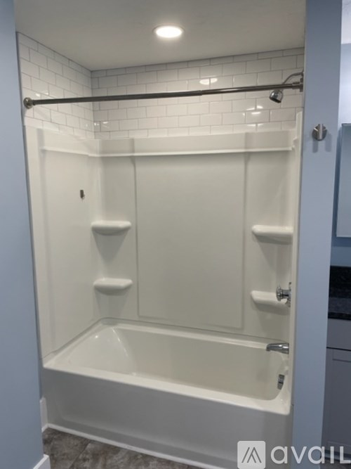 A white bathroom with a walk in shower.