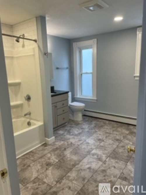 A bathroom with a toilet, sink, and bathtub.