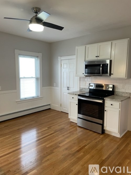A kitchen with a stove, oven, and microwave.