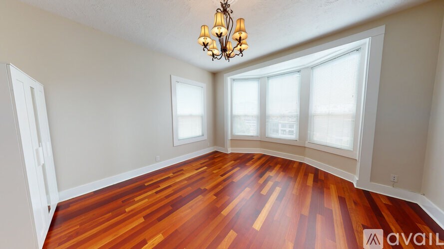 A room with wooden floors and a chandelier.