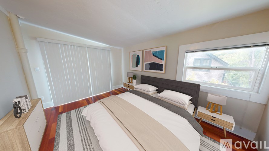 A bedroom with a large bed and a window.