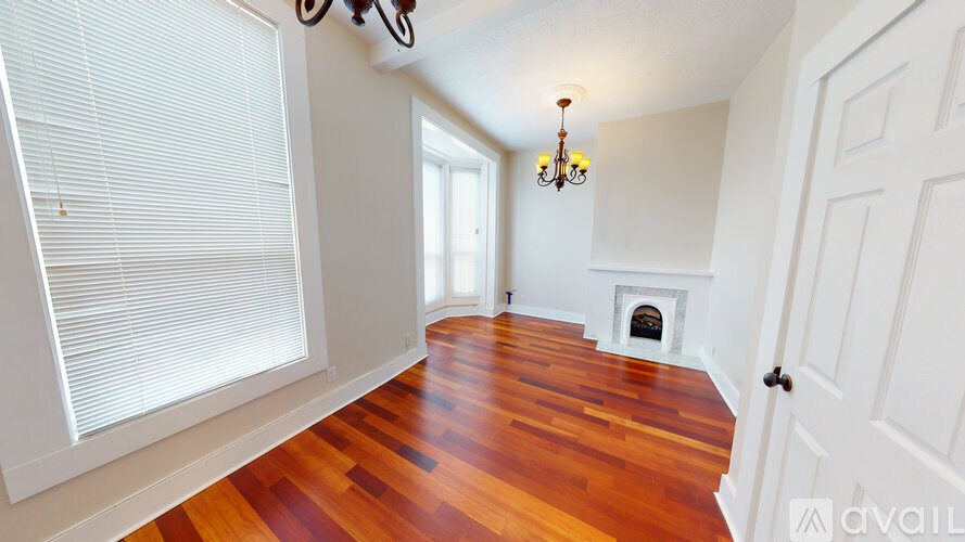 A room with wooden floors and a chandelier.