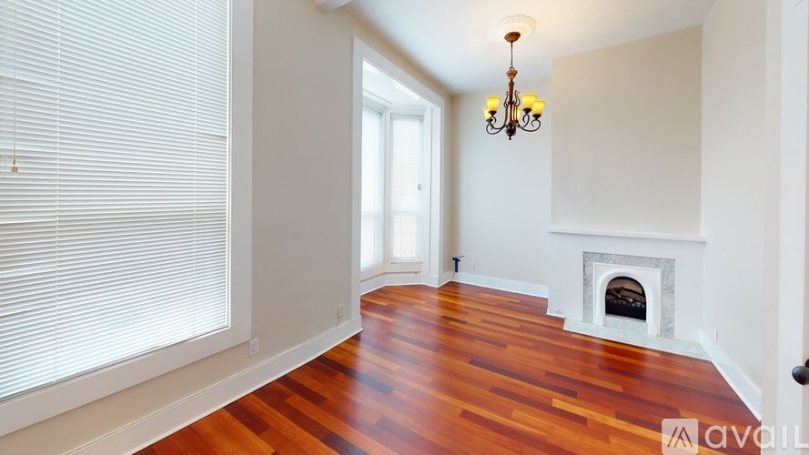 A room with a fireplace and a chandelier.