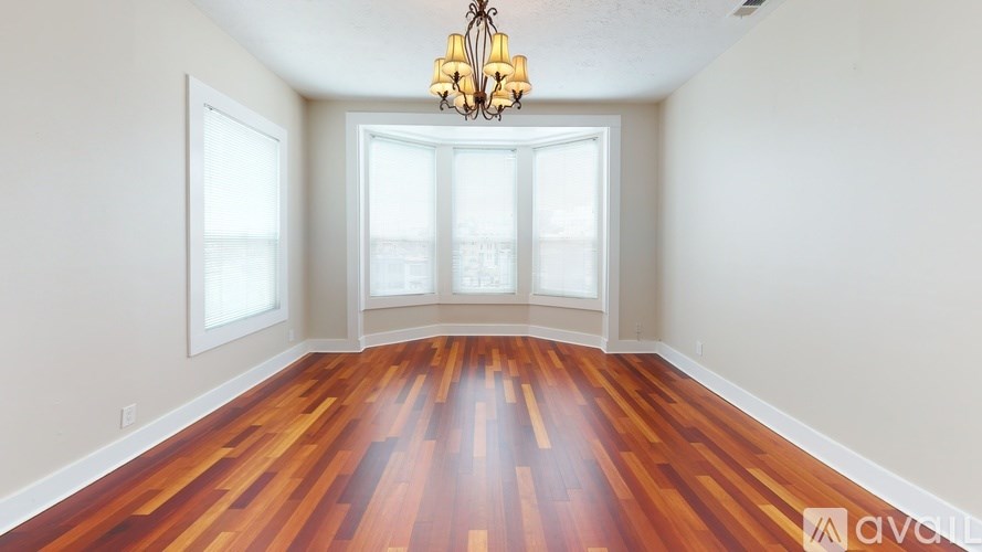 A room with wooden floors and a chandelier.