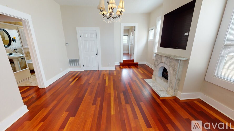 A room with wooden floors and a chandelier.