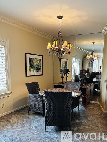 A dining room with a table set for four.