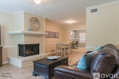 A living room with a fireplace and a couch.