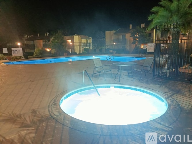 A hot tub in a backyard at night.