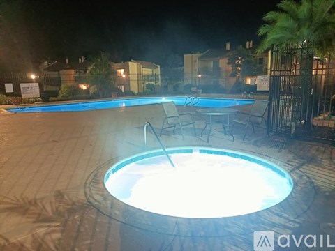A hot tub in a backyard at night.