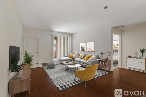 A living room with a yellow chair and a grey couch.