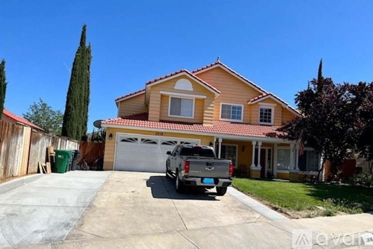 A house with a tan roof and a white garage door.