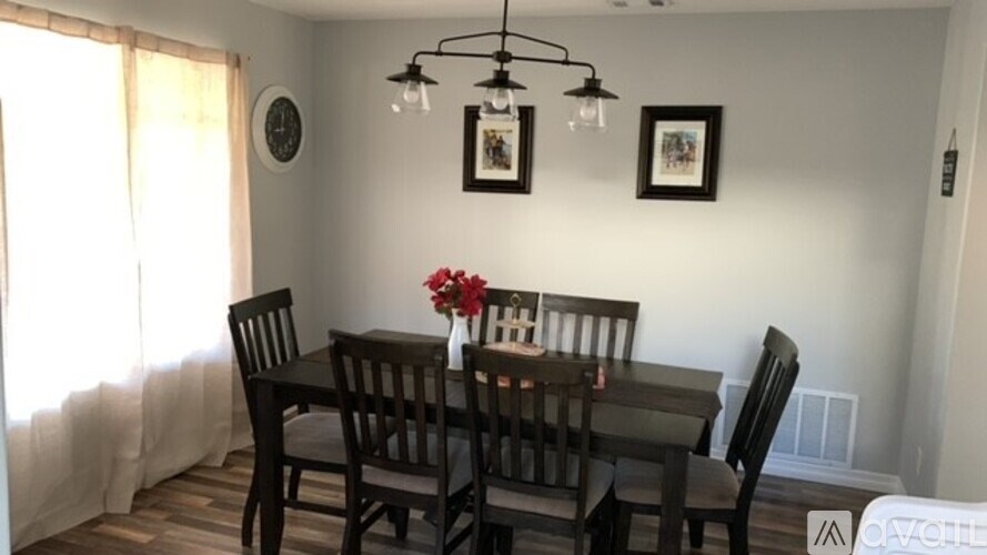 A dining room with a table set for four.