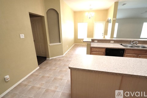 A kitchen area with a sink and a counter.