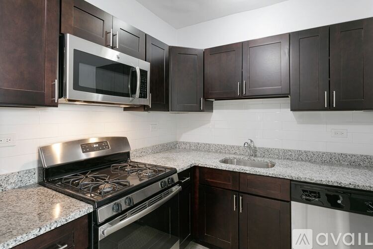 A kitchen with a stove top oven and microwave above it.