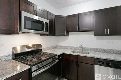 A kitchen with a stove top oven and microwave above it.