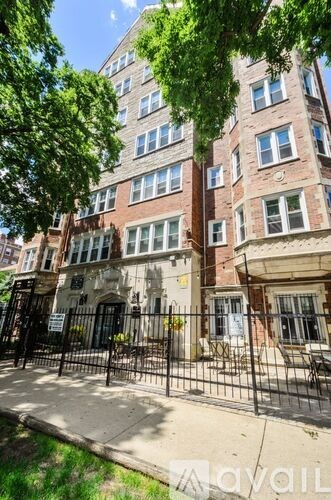 A tall building with a black gate in front.