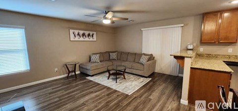 A living room with a beige couch and a coffee table.