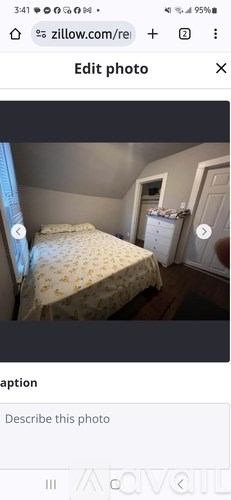 A bedroom with a bed, dresser, and wardrobe.