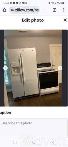 A white refrigerator is in a kitchen with a black oven.