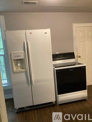 A white fridge with a water and ice maker dispenser on the door.