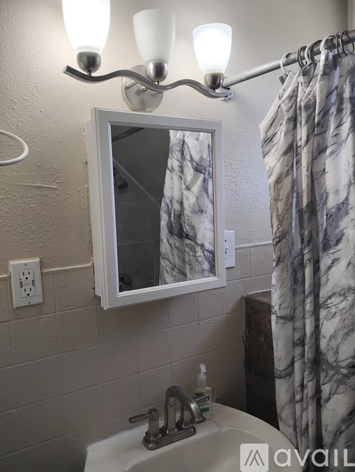 A stairway with a light on the ceiling and a door on the right.