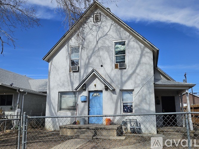 A house with a blue door is for sale.