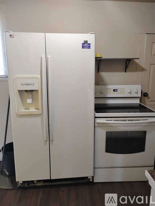 A white fridge and oven in a kitchen.