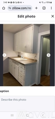 A kitchen with white cabinets and a countertop.