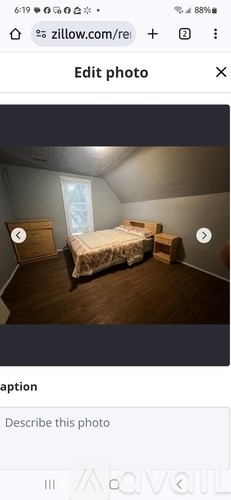 A bedroom with a bed, dresser, and window.