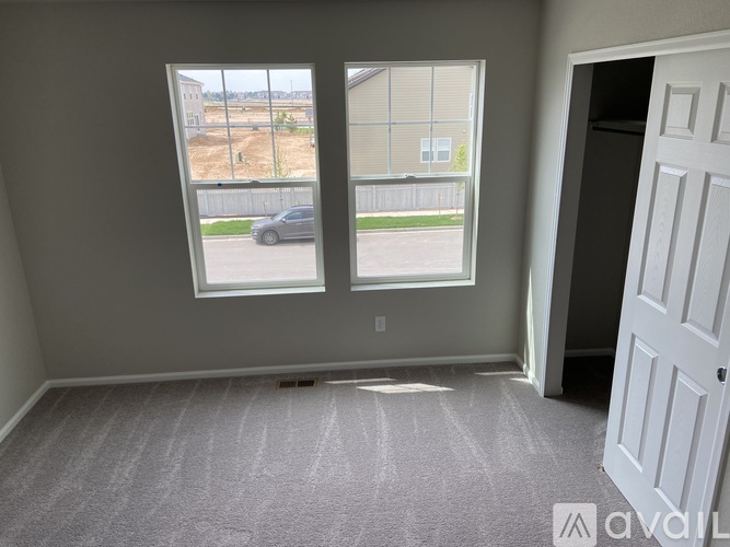 A room with a car parked outside the window.