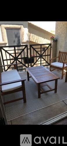 A patio with a table and chairs.