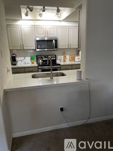 A kitchen with a stove top oven and a microwave above it.