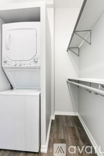 A white oven in a kitchen with wood flooring.