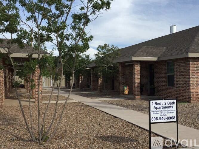 A sign in front of a building advertises 2 bedroom/2 bath apartments.
