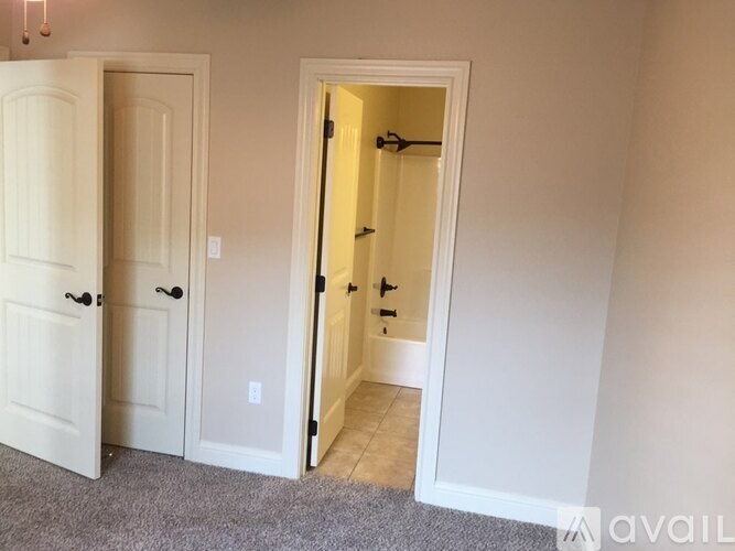 A white door is open to a hallway.