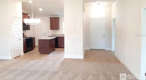 A well-lit kitchen with dark brown cabinets and a light-colored floor.