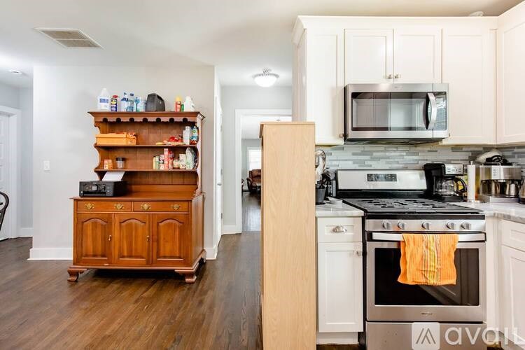 A kitchen with a wooden cabinet and a white oven.