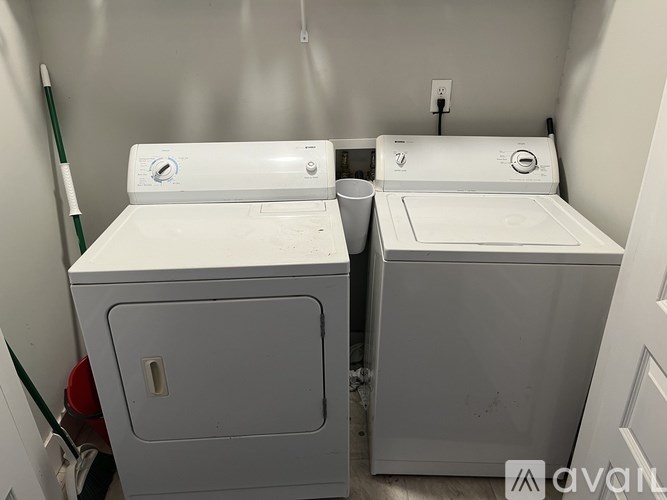 A white washing machine and dryer in a small laundry room.