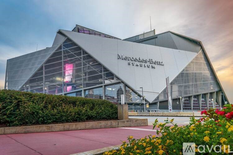A Mercedes-Benz Stadium with a red walkway in front.