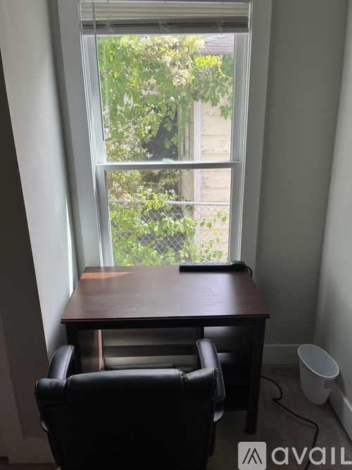A room with a desk and chair in it.
