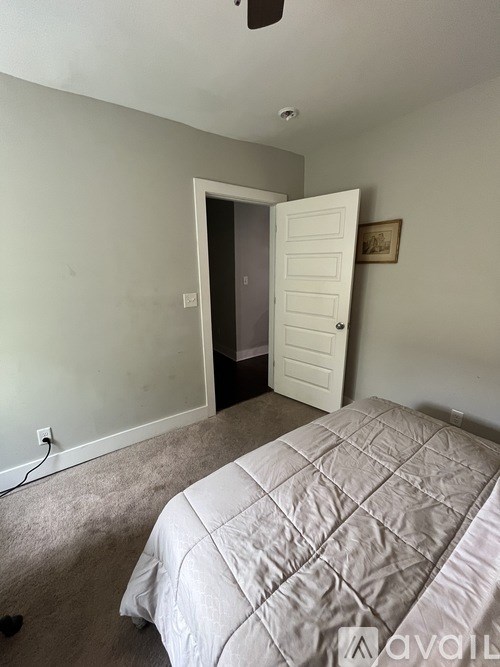 A black television sits on a wooden cabinet in a room with a window.