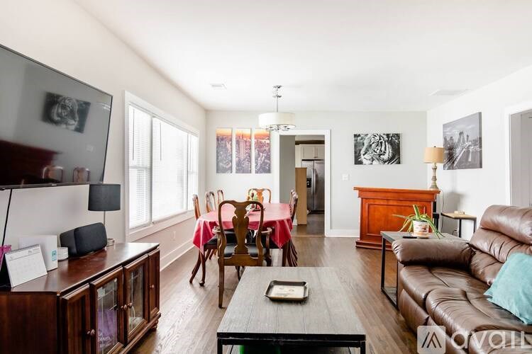 A living room with a brown leather couch and a wooden coffee table.