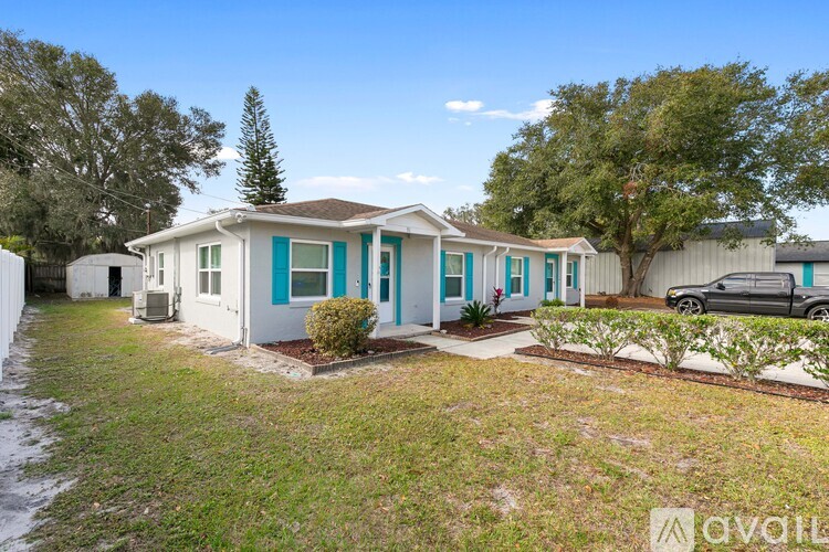 A row of houses with blue trim and white walls are for sale.