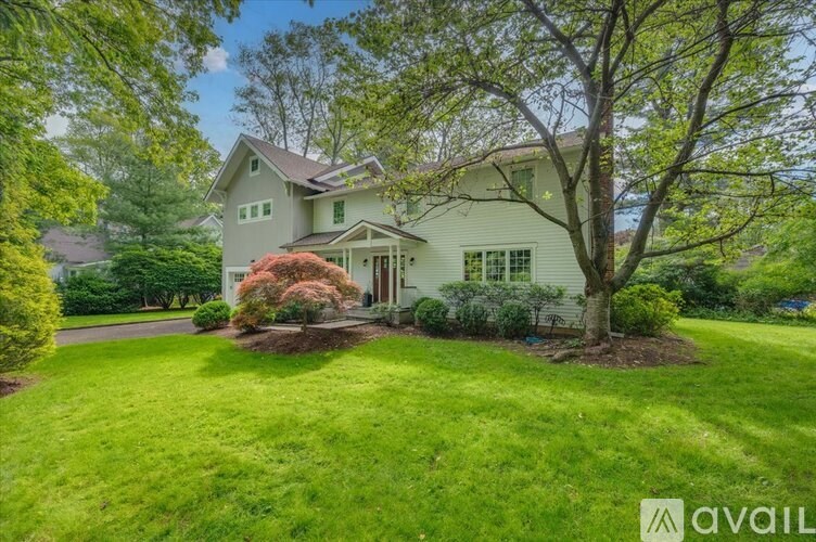 A two-story house with a garage and a driveway.