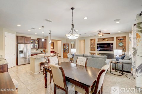 A modern dining room with a large table and chairs.