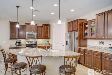 A kitchen with wooden cabinets and granite countertops.