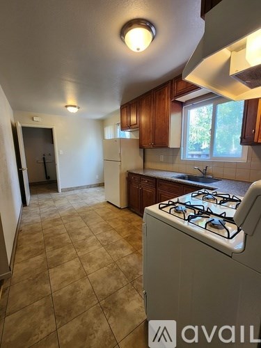 A kitchen with a stove and a window.