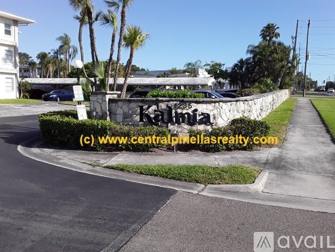 A street view with a sign that reads "Kamala" in front of a building.