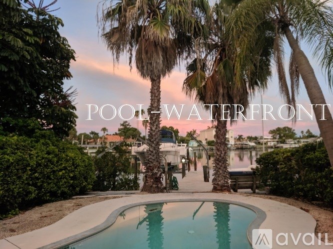A pool surrounded by palm trees with the words "POOL WATERFRONT" written across the top.