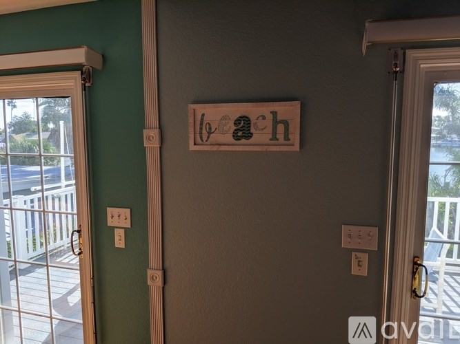 A wooden sign with the word "wach" on it hangs on a wall.
